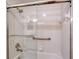 Shower with glass enclosure, tiled walls, and grab bars at 4264 Central Sarasota Pkwy # 122, Sarasota, FL 34238