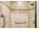 Walk-in shower with tiled walls and grab bars at 4264 Central Sarasota Pkwy # 122, Sarasota, FL 34238