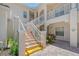 Clean condo building stairwell with light colored walls and railing at 4264 Central Sarasota Pkwy # 122, Sarasota, FL 34238