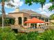 Relaxing clubhouse with outdoor seating overlooking a pond at 4372 Woodmans Chart # 143, Sarasota, FL 34235