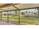 Screened porch overlooking a tranquil canal and lush landscape at 4372 Woodmans Chart # 143, Sarasota, FL 34235