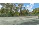 Community tennis court surrounded by lush Florida landscaping at 4372 Woodmans Chart # 143, Sarasota, FL 34235