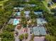 Aerial view of tennis courts, pool, and clubhouse at 4372 Woodmans Chart # 143, Sarasota, FL 34235