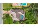 High-angle view of house, pool, and surrounding landscape at 462 Rubens E Dr, Nokomis, FL 34275