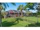 Backyard oasis featuring a screened patio, lush landscaping, and a fenced area at 462 Rubens E Dr, Nokomis, FL 34275