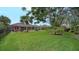 Large backyard with lush landscaping and pool view at 462 Rubens E Dr, Nokomis, FL 34275