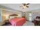 Spacious bedroom with king bed, wood-look floors and access to the bathroom at 462 Rubens E Dr, Nokomis, FL 34275