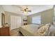 Guest bedroom with queen-size bed and a large window with blinds at 462 Rubens E Dr, Nokomis, FL 34275