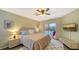 Main bedroom with king-size bed, access to the pool, and a large TV at 462 Rubens E Dr, Nokomis, FL 34275