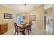 Charming dining room with a wooden table, four chairs, and a view of the kitchen at 462 Rubens E Dr, Nokomis, FL 34275