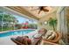 Relaxing lanai with wicker furniture and view of pool at 462 Rubens E Dr, Nokomis, FL 34275