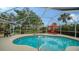 Inviting screened pool area with spa and lush landscaping at 462 Rubens E Dr, Nokomis, FL 34275