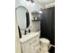 Modern bathroom with white vanity, black accents, and a shower/tub combo at 4717 Winslow Beacon # 7, Sarasota, FL 34235