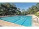 Community pool with lounge chairs and ample deck space at 4717 Winslow Beacon # 7, Sarasota, FL 34235