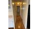 Long hallway with light wood flooring and access to bedrooms at 510 50Th Avenue W Dr, Bradenton, FL 34207