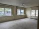 Living room with multiple windows and neutral carpeting at 510 50Th Avenue W Dr, Bradenton, FL 34207