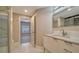 Bathroom with modern vanity, large mirror and walk-in shower at 5180 Northridge Rd # 101, Sarasota, FL 34238