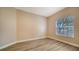 Bright bedroom with wood-look floors and a window at 5180 Northridge Rd # 101, Sarasota, FL 34238