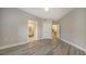 Bedroom with wood-look floors and access to bathroom and closet at 5180 Northridge Rd # 101, Sarasota, FL 34238