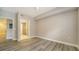 Bright bedroom with wood-look floors and an ensuite bathroom at 5180 Northridge Rd # 101, Sarasota, FL 34238