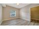 Spacious bedroom with wood-look floors and a large closet at 5180 Northridge Rd # 101, Sarasota, FL 34238