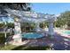 Community hot tub with pergola and surrounding landscaping at 5180 Northridge Rd # 101, Sarasota, FL 34238