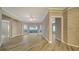 Bright living room with wood-look floors, sliding glass doors, and an accent wall at 5180 Northridge Rd # 101, Sarasota, FL 34238