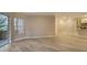 Living room with hardwood floors, brick wall, and sliding glass doors at 5180 Northridge Rd # 101, Sarasota, FL 34238