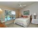 Bright bedroom with lake view and ceiling fan at 5251 Mahogany Run Ave # 524, Sarasota, FL 34241