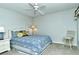 Bedroom with ceiling fan and blue bedding at 5251 Mahogany Run Ave # 524, Sarasota, FL 34241