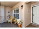 Bright condo entryway with wicker chair and flowers at 5251 Mahogany Run Ave # 524, Sarasota, FL 34241