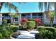 Landscaped condo building with walkway and lush greenery at 5251 Mahogany Run Ave # 524, Sarasota, FL 34241