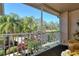 Relaxing screened balcony with patio furniture and view at 5251 Mahogany Run Ave # 524, Sarasota, FL 34241