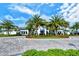 Community clubhouse with palm trees and circular drive at 5552 Eagle Creek Rd, Sarasota, FL 34238