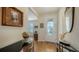 Bright entryway with hardwood floors, glass-paned door, and decorative accents at 5552 Eagle Creek Rd, Sarasota, FL 34238