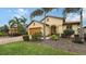 Single-story home with landscaped yard, orange garage door, and palm trees at 5552 Eagle Creek Rd, Sarasota, FL 34238