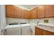 Laundry room with washer, dryer, and ample cabinets at 5552 Eagle Creek Rd, Sarasota, FL 34238