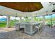 Covered outdoor kitchen with granite counters and seating at 5552 Eagle Creek Rd, Sarasota, FL 34238