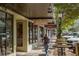 Person walking past shops and restaurants on a sidewalk at 5552 Eagle Creek Rd, Sarasota, FL 34238