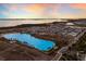 Aerial view of community with lagoon pool at sunset at 5902 Red Mangrove Ln, Bradenton, FL 34210