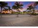 Sandy beachfront area with palm trees and sunset view at 5902 Red Mangrove Ln, Bradenton, FL 34210