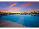 Stunning community pool at sunset with palm trees reflecting in the water at 5902 Red Mangrove Ln, Bradenton, FL 34210