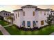 Luxury home with a modern design, featuring a light-colored facade and lush landscaping at 5902 Red Mangrove Ln, Bradenton, FL 34210