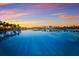 Expansive lagoon pool reflecting the sunset sky at 5902 Red Mangrove Ln, Bradenton, FL 34210