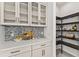 Modern kitchen pantry with glass-front cabinets and shelving at 5902 Red Mangrove Ln, Bradenton, FL 34210