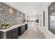 Modern wet bar with mosaic tile backsplash and dark cabinetry at 5902 Red Mangrove Ln, Bradenton, FL 34210