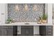 Stylish wet bar featuring a mosaic tile backsplash and sleek countertop at 5902 Red Mangrove Ln, Bradenton, FL 34210