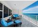 Ocean view balcony with wicker furniture and stunning blue water at 603 Longboat Club Rd # 1102N, Longboat Key, FL 34228