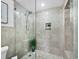 Modern bathroom with a glass shower and marble tile at 603 Longboat Club Rd # 1102N, Longboat Key, FL 34228