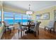 Ocean view dining room with round table and four patterned chairs at 603 Longboat Club Rd # 1102N, Longboat Key, FL 34228